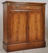 A Regency style yew wood inlaid side cabinet. Plinth base with cupboard under short drawer above.