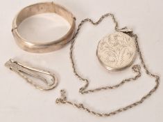 A silver hallmarked ladies bangle being chase decorated together with a silver 925 locket and a