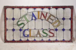 A large 19th century stained glass window pane being of leaded construction bearing arched