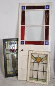 An Edwardian painted stained glass door having coloured and clear glass panels with bakelite knob
