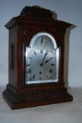 A late 19th century / early 20th century oak cased bracket clock. The silvered dial with