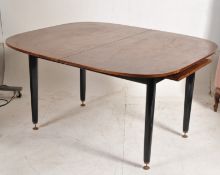 A 1960's G-Plan retro original tola wood large extending dining table. Raised on ebonised legs