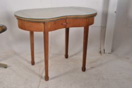 A 1930's Art Deco oak Kidney shaped writing table desk. Raised on square tapered supports with spade