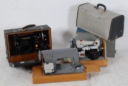 2 vintage sewing machines complete in the original carry cases
