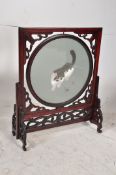 A good rosewood Chinese table top screen having fret carved detailed stand with revolving glass