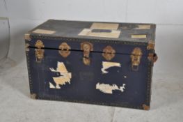 A large 20th century steamer trunk having hinged lid with open storage.