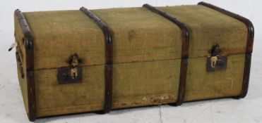 A 19th century canvas and wooden bound steamer trunk in green having hinged clasps to front with