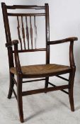 An Edwardian walnut rattan weave low chair on turned supports with detail to back rest.