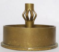 A trench art candlestick / ashtray  / paperweight being constructed from two artillery shells with a