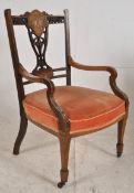 An Edwardian mahogany inlaid salon armchair. Raised on square tapered legs with spade feet.