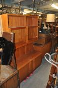 A pair of Danish bookcase / display cabinets in teak. The cupboards to base having suspended