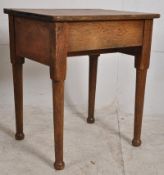 A Victorian solid oak childs school desk. Turned legs with hinged top and inkwell recess