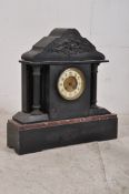 A Victorian slate and marble mantle clock. The 8 day movement housed in neo classical case with