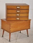 A good retro 1950's sewing box on tapered legs having lift up top with exposed dovetail joints.
