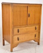 A 1930's Oak Art Deco tallboy / chest of drawers. Raised on squared legs with a body of 2 drawers