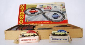 A vintage Marx ' Motorway ' race set with both original tinplate clockwork cars (in original