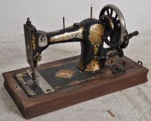 A Victorian Jones Family CS hand crank sewing machine. Complete in case with key.