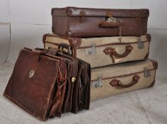 A stack of vintage suitcases together with a collection of gentlemans leather attache cases ( see