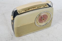 Original Bush Radio TR82c with circular dial to front in a cream finish with carry handle to top
