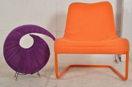A retro style orange canvas tubular metal framed easy chair / armchair, along with a purple canvas