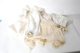 A collection of vintage clothes to include petticoat, childrens gown and other items.