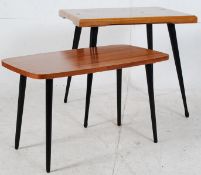 3 retro 1950's coffee tables being raised on tapered ebonised legs having lightwood table tops.