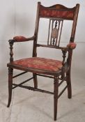 An Edwardian mahogany inlaid salon armchair. Raised on turned legs united by stretchers having red