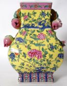 A 20th century chinese oriental yellow enamel painted vase with affixed china fruit detail to