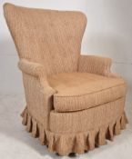 A 1950`s American wingback armchair made by the North Hickory Furniture Company, USA. The rounded