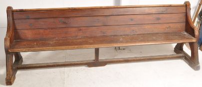 A Victorian Arts & Crafts oak and pitch pine church pew. Shaped supports being peg jointed with