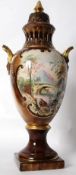 A large hand decorated Staffordshire urn / vase in brown, with removable lid and terraced base.