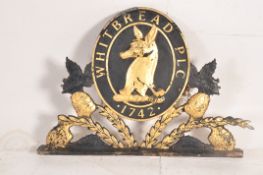 A 20th century Shabby Chic Whitbread PLC armorial pub sign constructed of resin being ebonised with