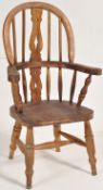 A Victorian style childs windsor chair. Turned legs united by strethers having saddle seat with