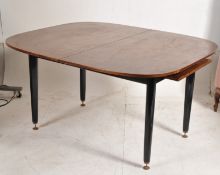 A 1960`s G-Plan retro original tola wood large extending dining table. Raised on ebonised legs with