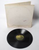 BEATLES: A Beatles ` White Album, ` being incorrectly printed with the inside cover being upside