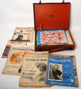 A vintage leather suitcase filled with sheet music to include Moon River and many others.