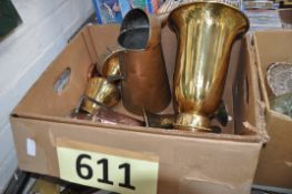 A large brass urn along with two brass vases, a copper pouring jug and rustic copper jug