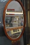A mahogany oval mirror