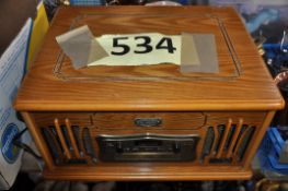 A vintage wooden cased record player and radio by Daklin from the museum series