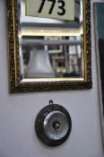 A gilt effect mirror along with a cornish stone set barometer.