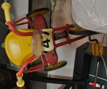 A vintage childs trike in red and yellow
