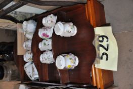 Two display cabinets with Royal Stratford teapots Royal Stratford Scented garden pots.