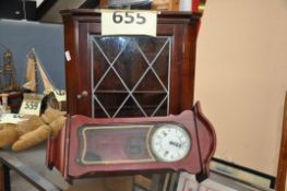 A mahogany antique style corner cabinet together with a wall clock