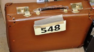 A vintage 1940's leather travel suitcase with brass locks.