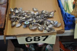 A large collection of silver plate souvenir spoons. 40+, including one Caithness glass topped