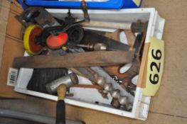 A collection of vintage tools to include saws, large industrial style hand drill, spirit level and