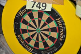 A dart board in a large yellow rubber surround