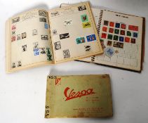 A collection of vintage stamps in two albums, along with an original Vespa motorcycle / moped