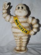 A vintage style cast metal Michelin advertising figure, depicting Bibendum waving. Hand painted