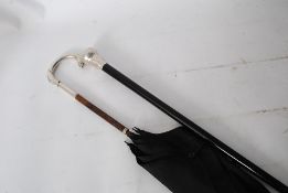A hallmarked silver knop top ebonised promenade cane. The ebonised tapered stem having chase